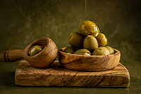 Drizzling golden olive oil over fresh harvest